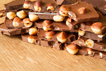 Dark and milk chocolate with hazelnut on a wooden background