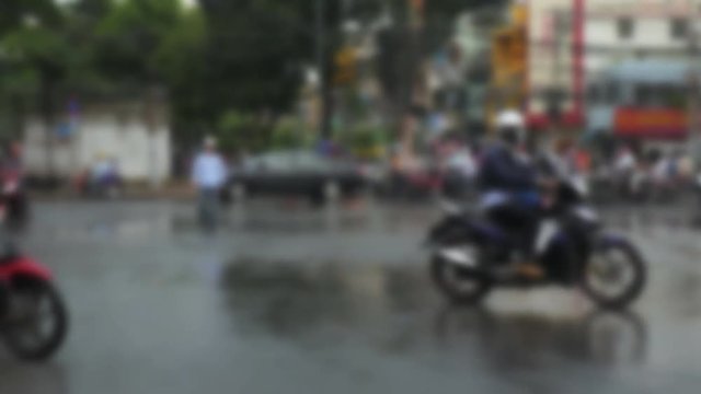 People ride scooters in Vietnam, soft focus
