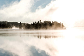 Lake of two rivers algonquin national park ontario canada sunset sunrise with fog foggy mystical atmosphere background