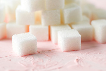 soft focus close up macro sugar cubes on pink background