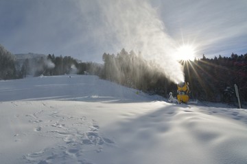 Snow cannons making artificial snow on a ski slope in Poiana Brasov winter resort
