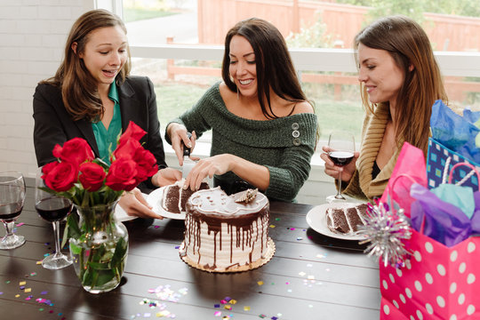 female friends sharing cake at birthday party
