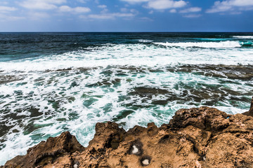 Waves breaking on coastal rocks