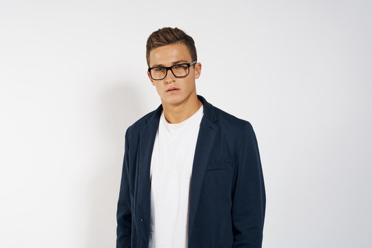 business man in a jacket about glasses on a light background