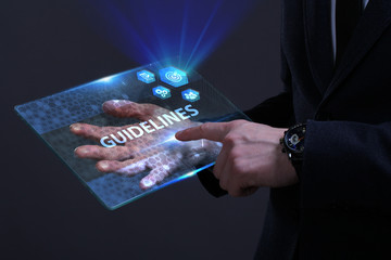 Business, Technology, Internet and network concept. Young businessman working on a virtual screen of the future and sees the inscription: Guidelines