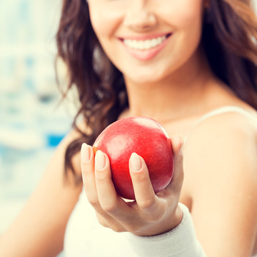 Woman with apple, at fitness center