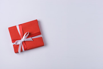 Red gift box on white wooden background