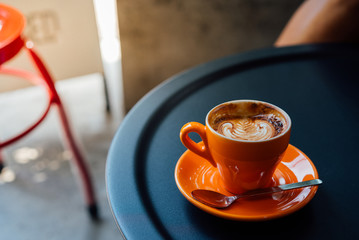 coffee in orang cup on black table top