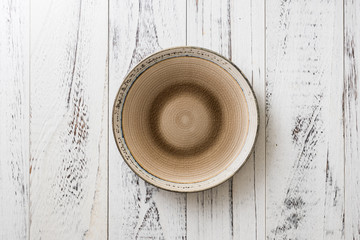Plate on white wooden background