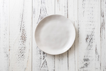 White Plate on white wooden background