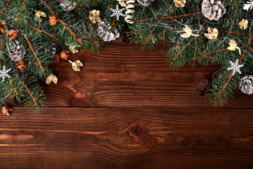 Christmas background with xmas tree and sparkle bokeh lights on wooden canvas background. Merry christmas card. Winter holiday theme. Happy New Year. Space for text. Happy Holidays