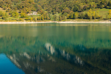 Obraz premium Fresh transparent emerald green water of Tenno lake in Trentino, Italy, Europe