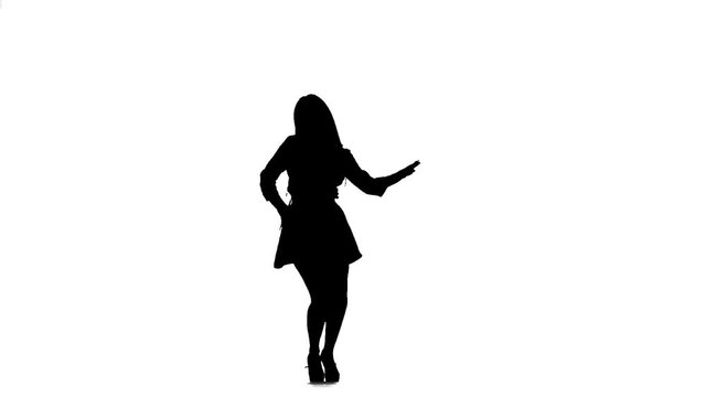 Girl is dancing a sexy dance. Silhouette. White background. Slow motion