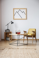 End table with armchair, lamp and a frame