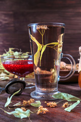 linden tea on a background of dried lime flowers, lemon balm and St. John's wort