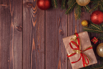 Christmas gift boxes and fir tree  on wooden background.