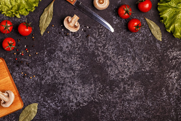Ingredients for cooking on dark concrete background.