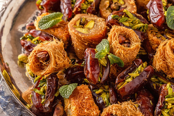 Eastern sweets on old wooden table.