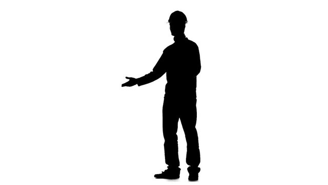 Builder talks to the contractors and thumbs up. Silhouette. White background. Slow motion