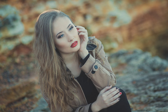 Seductive Sexy Lady Girl With Romantic Pout Red Lips And Pinky Cheeks Wearing Stylish Jacket Dress And Shorts With Autumn Boots Posing At Rocky Beach Sea Side With Make Up On Face I Romantic Episode