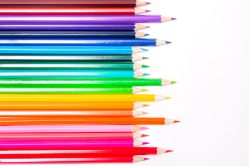 Fototapeta premium line of colored pencils white background, a symbol of LGBT