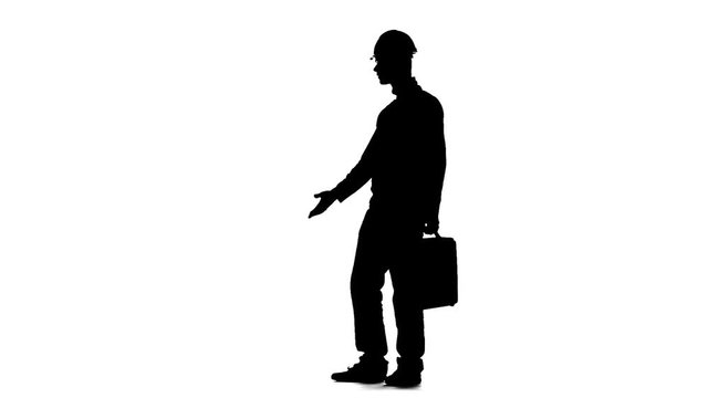 Builder with a diplomat in his hands and a helmet on his head. Silhouette. White background. Slow motion