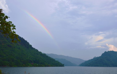 rainbow on rain cloud in lake
