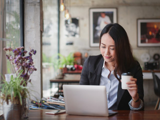 Asian business woman with laptop happy and smile concept success work