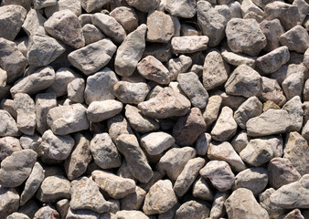 large gray stones on the shore, texture of light stones, natural background.