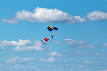 a parachutist jump against the blue sky
