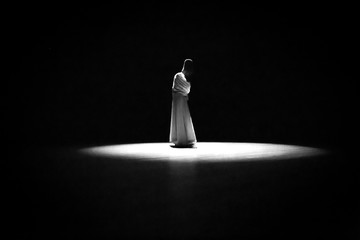 the image of a whirling Dervish in the darkness
