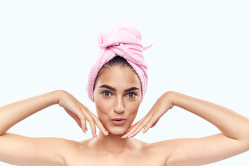 girl with a towel on her head with her hands near her face