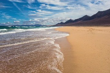 Beautiful sand beach Cofete surrounded with scenic mountains