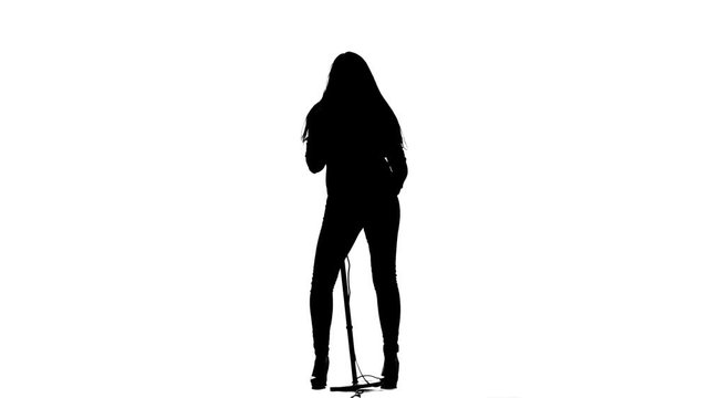 Girl sings in a retro rock song microphone. White background. Silhouette