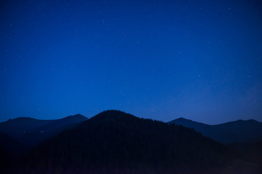 Silhouette of mountain range at night