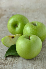 Green apples on wooden background