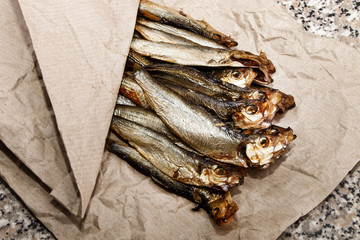 smoked oily sprats on brown kitchen paper