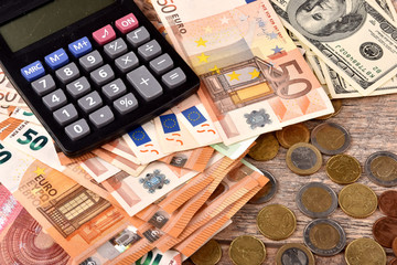 Calculator and money on the table.