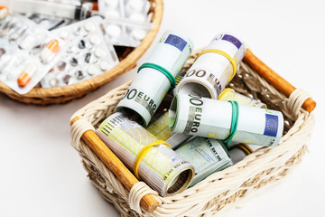 Fototapeta na wymiar Different medications and pills with euro banknotes on a white background