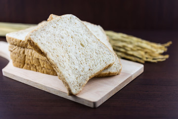 Sliced Whole wheat bread on Chopping Wood