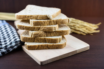 Sliced Whole wheat bread on Chopping Wood and tablecloth background