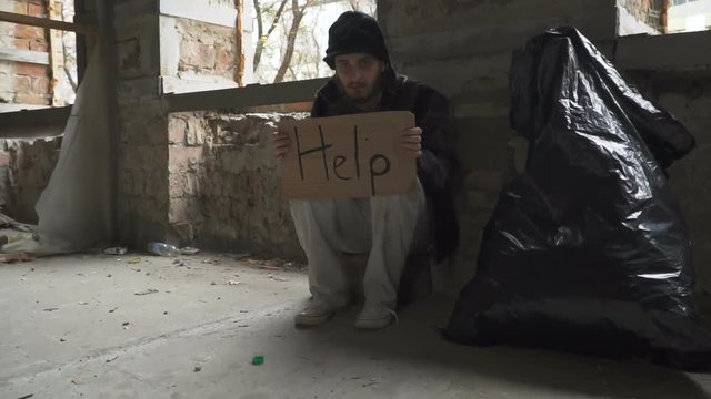 Frozen hungry homeless with cardboard "help"