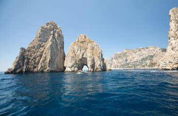 Fototapeta na wymiar Faraglioni Rocks on Capri Island, Italy. Rock's names left to left: Stella, Mezzo and Scopolo or Fuori