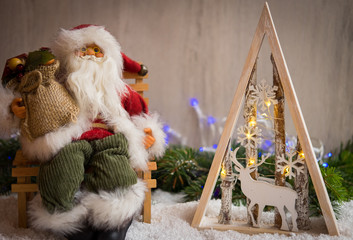 Obraz premium Christmas ornaments with snow, pine tree, Santa Claus and xmas lights