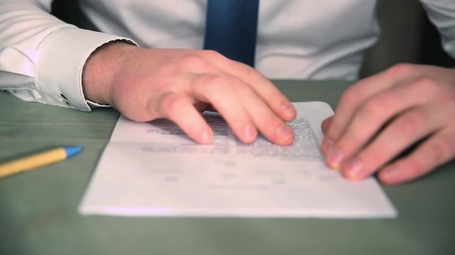 businessman reading and signing business partnership contract in office