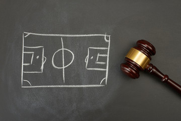 Judge gavel on blackboard background with painted soccer court. - 180838349