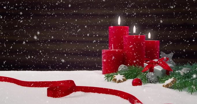 Third Sunday of Advent - Beautiful snowfall in front of a Christmas decoration arrangement on a snowy table in front of a wooden background - ProRes