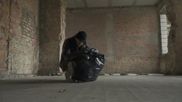 Dirty poor homeless find phone in garbage bag