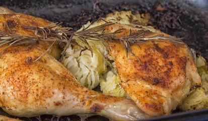 Roasted  chicken legs in the pan take out from the oven.