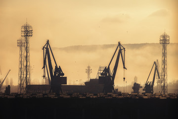Fototapeta premium Panoramic view toward sea port and industrial cranes